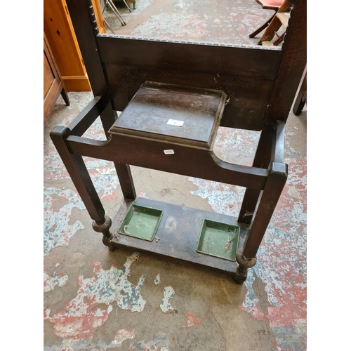 32 - A mid 20th century oak hall stand with central mirror, glove box and two drip trays - approx. 183cm ... 