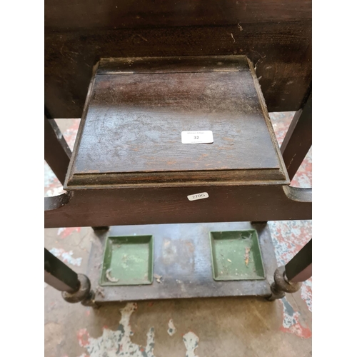 32 - A mid 20th century oak hall stand with central mirror, glove box and two drip trays - approx. 183cm ... 