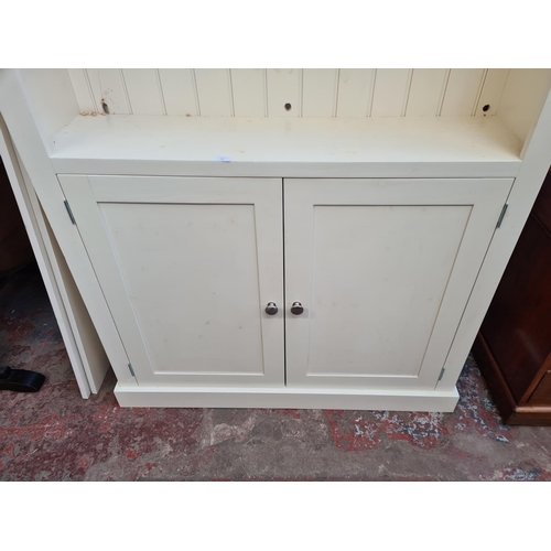 34 - A modern white painted bookcase with four shelves and two lower cupboard doors - approx. 213cm high ... 