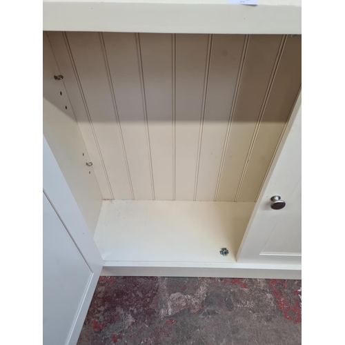 34 - A modern white painted bookcase with four shelves and two lower cupboard doors - approx. 213cm high ... 