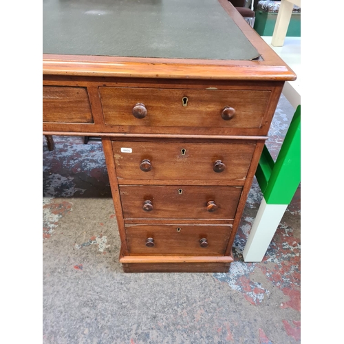 37 - A Victorian mahogany and green leather pedestal desk with eight drawers - approx. 77cm high x 152cm ... 