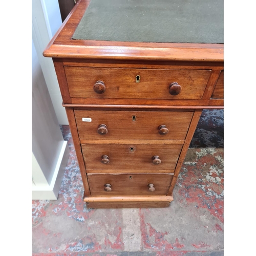 37 - A Victorian mahogany and green leather pedestal desk with eight drawers - approx. 77cm high x 152cm ... 