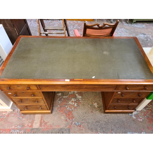 37 - A Victorian mahogany and green leather pedestal desk with eight drawers - approx. 77cm high x 152cm ... 