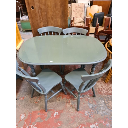 40 - A modern grey painted extending dining table and four matching chairs