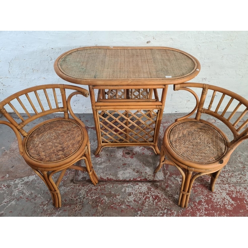 41 - A mid 20th century bamboo and wicker three piece dining suite comprising table and two chairs - appr... 