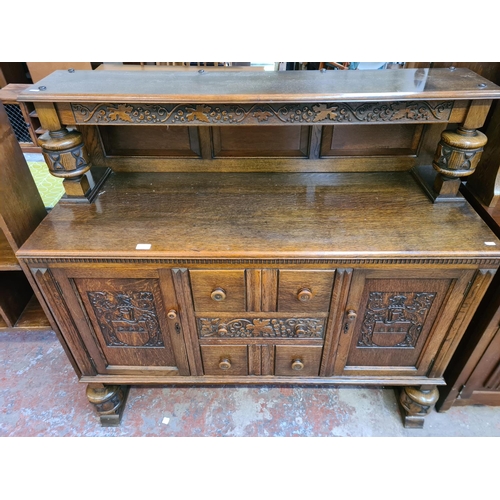 44 - A 17th century style carved oak court cupboard - approx. 129cm high x 136cm wide x 50cm deep