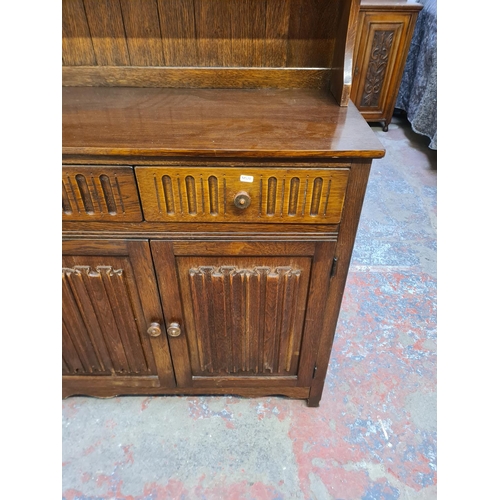 45 - An oak linenfold Dutch dresser - approx. 179cm high x 95cm wide x 44cm deep