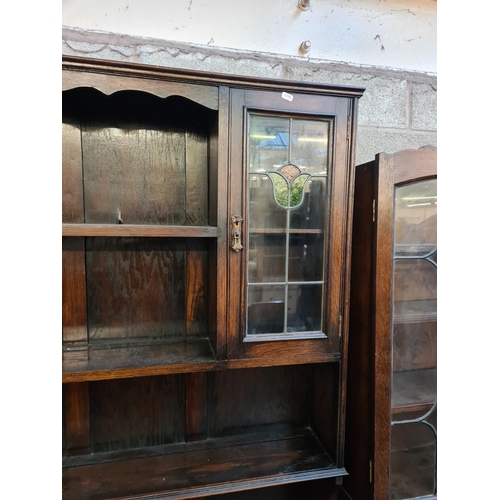 5 - A 1930s oak dresser with two stained and leaded glass doors and four drawers