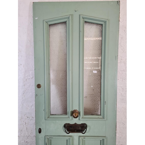 60 - A green painted pine exterior door with brass handle and letterbox - approx. 201cm high x 81cm wide