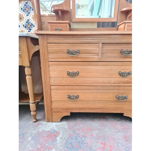 61 - An Edwardian satinwood dressing chest with upper bevelled edge mirror, two trinket drawers, two shor... 