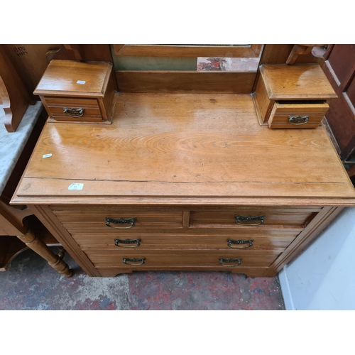 61 - An Edwardian satinwood dressing chest with upper bevelled edge mirror, two trinket drawers, two shor... 