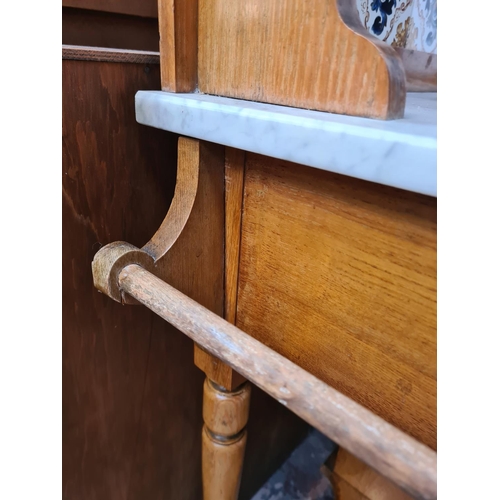 62 - An Edwardian satinwood washstand with marble top and ceramic tile splashback - approx. 128cm high x ... 