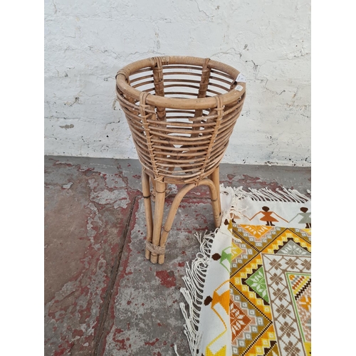 73 - Two items, one bamboo and wicker plant stand and one cross stitched throw - approx. 105cm²