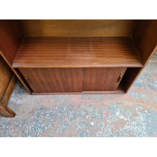 75 - A mid 20th century Beaver & Tapley Ltd mahogany bookcase with two sliding doors and two upper shelve... 