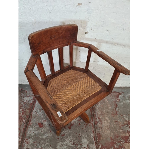 8 - A vintage elm and rattan office desk chair