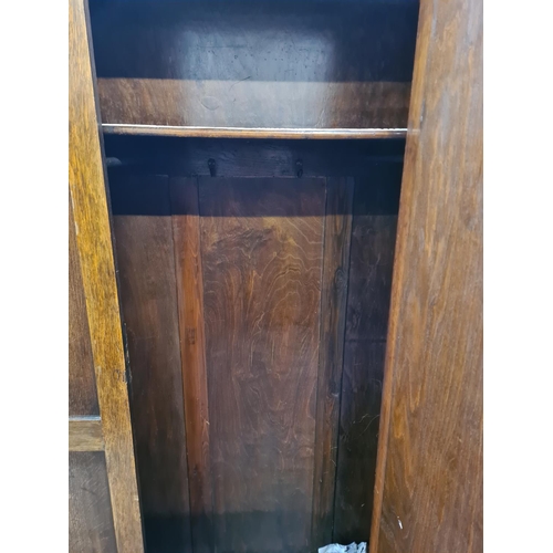 83 - An early 20th century oak mirror door wardrobe - approx. 187cm high x 118cm wide x 44cm deep