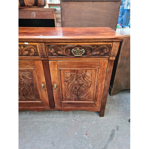 84 - An Edwardian carved mahogany sideboard with two drawers and two cupboard doors - approx. 93cm high x... 