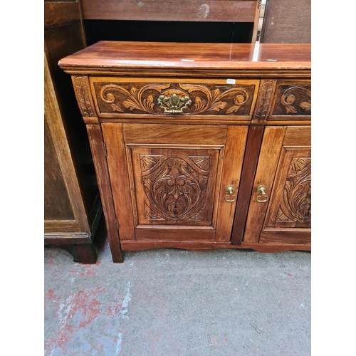 84 - An Edwardian carved mahogany sideboard with two drawers and two cupboard doors - approx. 93cm high x... 