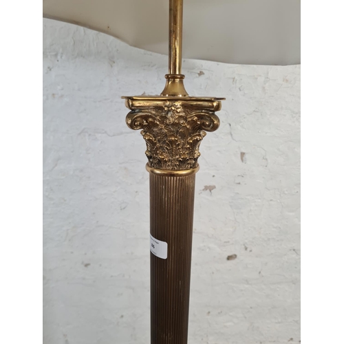 86 - A brass Corinthian column standard lamp with four lion paw supports - approx. 139cm high