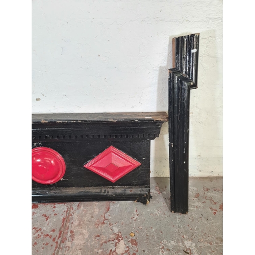 9 - A Victorian black and red painted fire surround