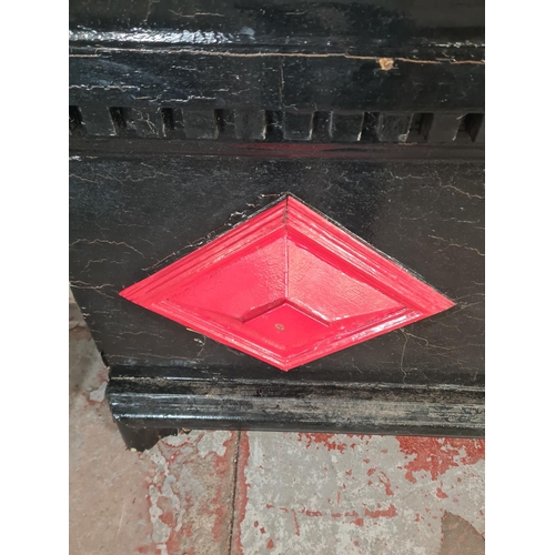 9 - A Victorian black and red painted fire surround