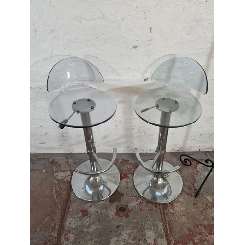 97 - Three pieces of furniture, two clear plastic and chrome plated kitchen bar stools and one wrought ir... 