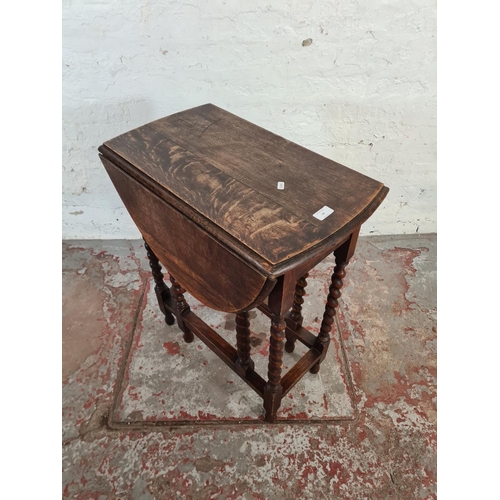 99 - An early 20th century oak drop leaf gate legged oval occasional table on barley twist supports - app... 