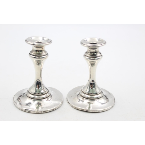 1257 - A pair of Edwardian Henry Matthews hallmarked Birmingham silver tapered candlesticks, dated 1906