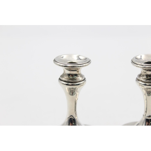 1257 - A pair of Edwardian Henry Matthews hallmarked Birmingham silver tapered candlesticks, dated 1906