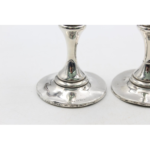 1257 - A pair of Edwardian Henry Matthews hallmarked Birmingham silver tapered candlesticks, dated 1906