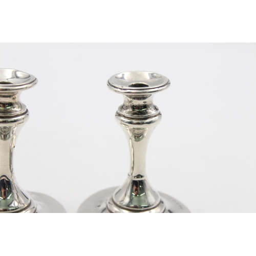 1257 - A pair of Edwardian Henry Matthews hallmarked Birmingham silver tapered candlesticks, dated 1906