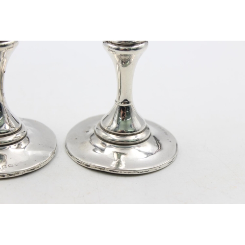 1257 - A pair of Edwardian Henry Matthews hallmarked Birmingham silver tapered candlesticks, dated 1906