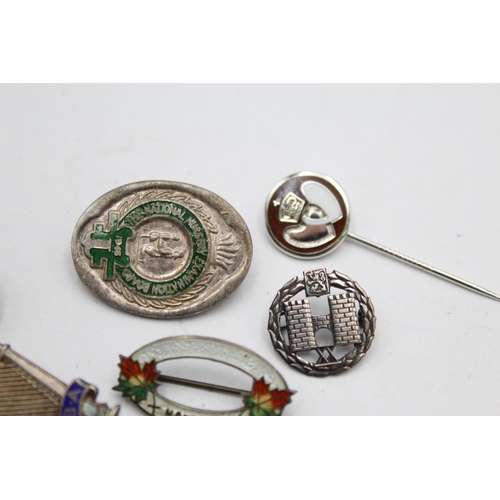 1261A - Six vintage silver pin and lapel badges, four sterling silver, one .830 silver and one stamped silve... 