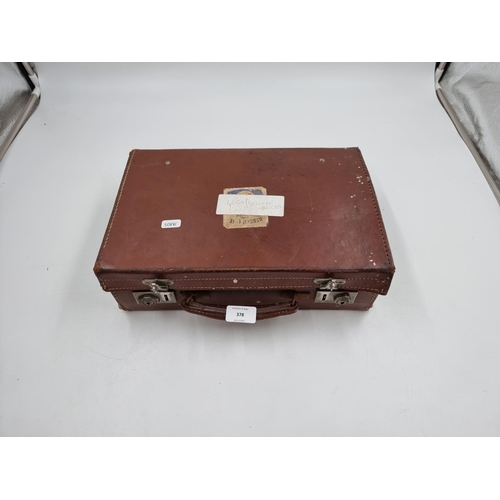 378 - A vintage leather child's travel trunk containing assorted Lego