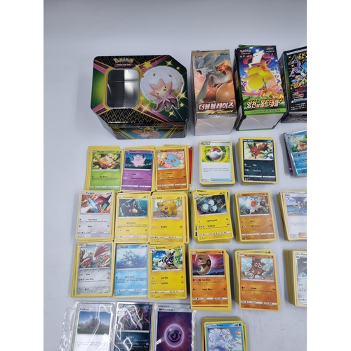 384 - A large collection of Pokémon trading cards to include Japanese etc.