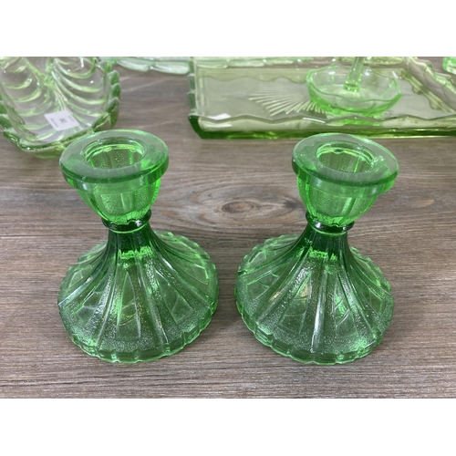 288 - A collection of vintage uranium glassware to include candlesticks, ring holder etc.