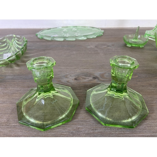 288 - A collection of vintage uranium glassware to include candlesticks, ring holder etc.