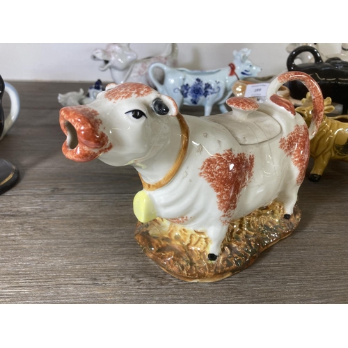 289 - A collection of ceramic cow creamers and figurines to include Fairmont & Main Down On The Farm Lulu,... 