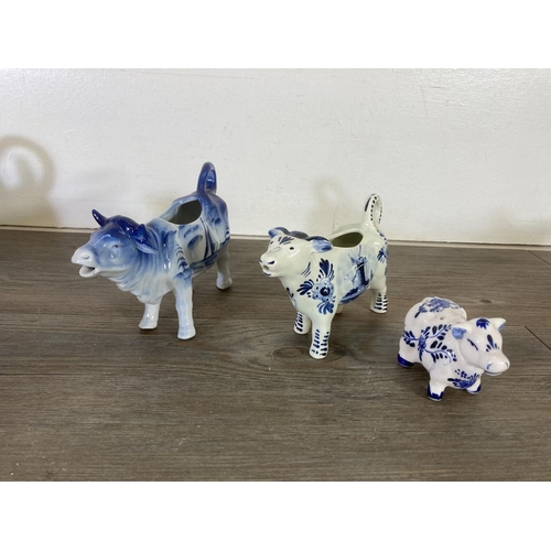 289 - A collection of ceramic cow creamers and figurines to include Fairmont & Main Down On The Farm Lulu,... 