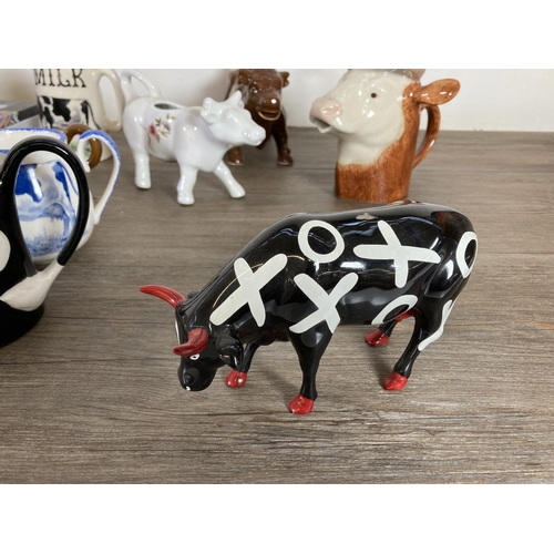 291 - A collection of cow themed ceramics to include Border Fine Arts The Young Herriot Studio Collection ... 