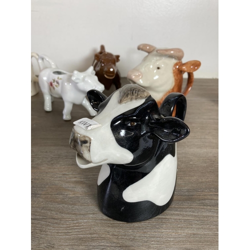 291 - A collection of cow themed ceramics to include Border Fine Arts The Young Herriot Studio Collection ... 