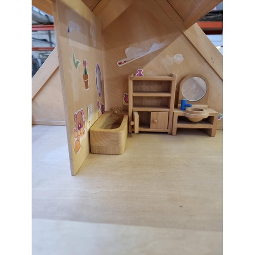 405 - A wooden three piece doll's house with various furniture and accessories