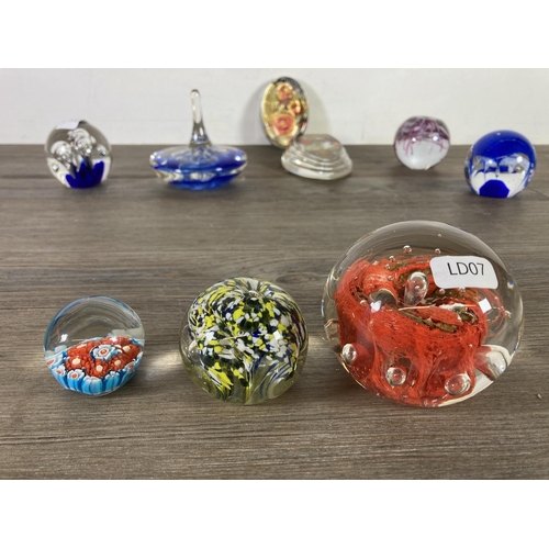 303 - Nine studio glass paperweights