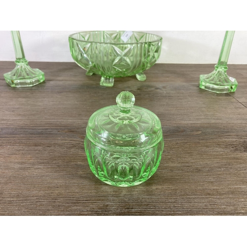 320 - Four pieces of vintage uranium glassware, one 24cm bowl, two candlesticks and one lidded jar