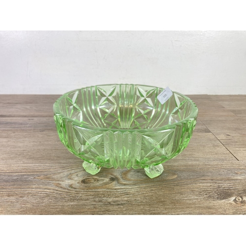 320 - Four pieces of vintage uranium glassware, one 24cm bowl, two candlesticks and one lidded jar