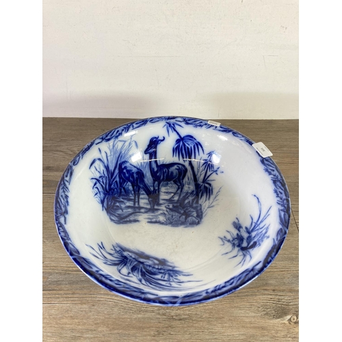 321 - Two pieces of blue and white transferware china, one 37cm bowl and one 34cm lidded storage barrel