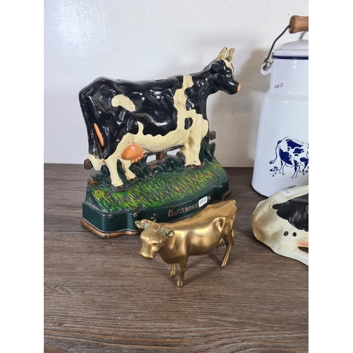 333 - Six pieces of metalware, two cast metal cow doorstops, two enamel milk churns, one brass cow figurin... 