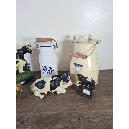 333 - Six pieces of metalware, two cast metal cow doorstops, two enamel milk churns, one brass cow figurin... 