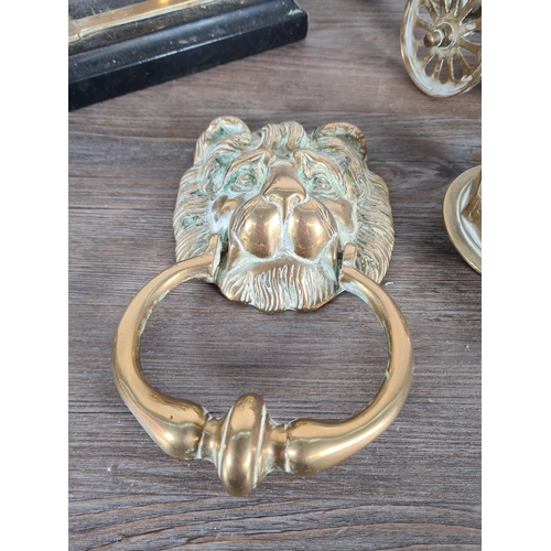 342 - Six pieces of brassware to include lion head door knocker, two models of cannons, desktop service be... 