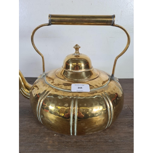 344 - A mid 20th century beaten brass kettle - approx. 25cm high x 35cm wide